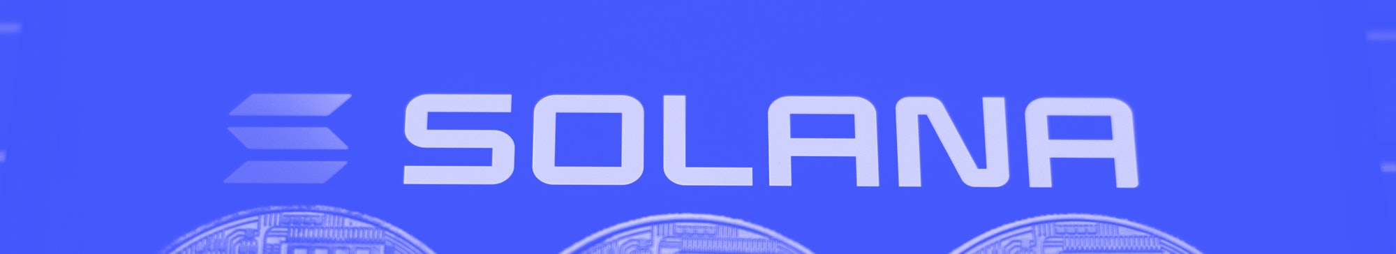 Solana logo displayed on a phone screen and representation of cryptocurrencies are seen in this illu...