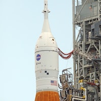 A close-up view showing the Orion spacecraft atop the massive Artemis I Space Launch System rocket a...