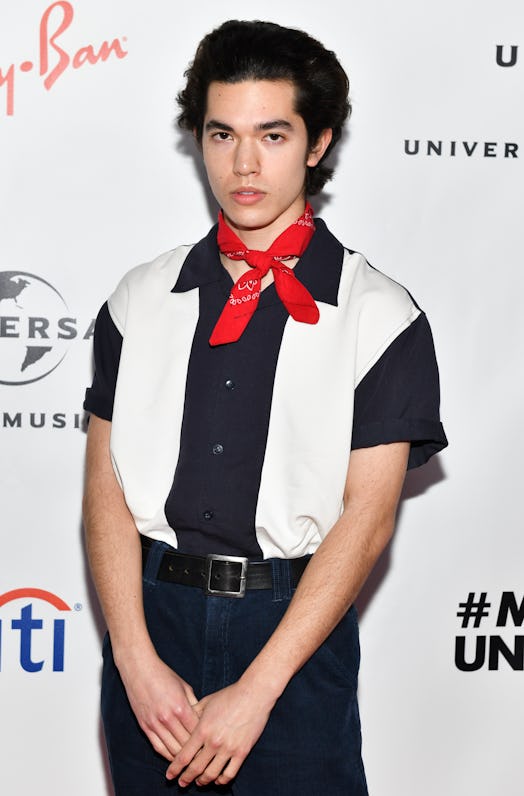 Conan Gray wearing a bowling shirt and a red bandana with jeans