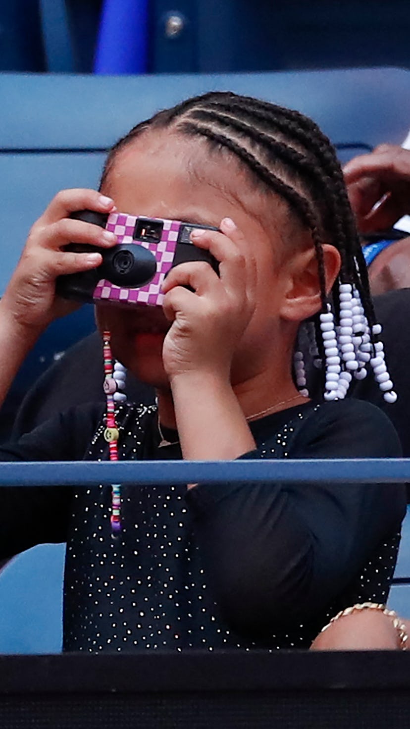 US player Serena Williams' daughter Alexis Olympia takes a picture before her mother plays against M...