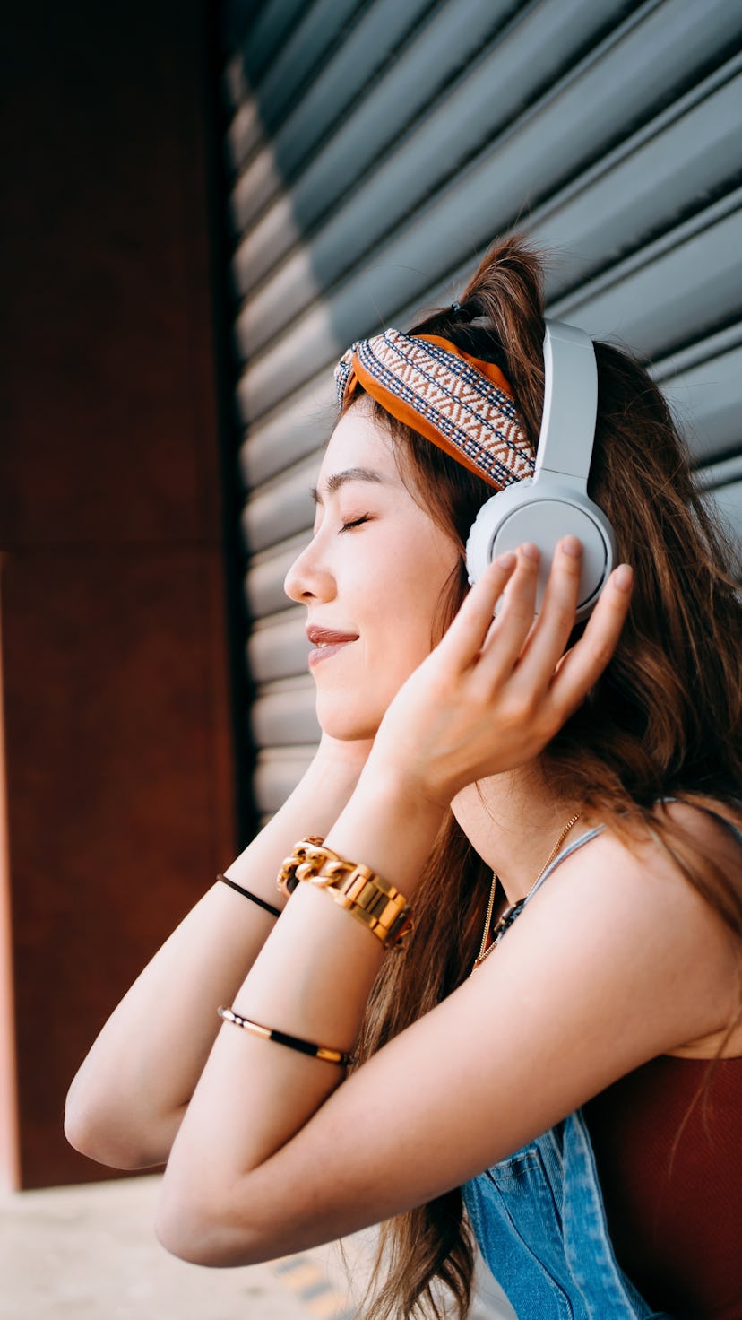 Woman listening to music. Astrologer Lauren Ash reveals which zodiac signs will have the luckiest Se...