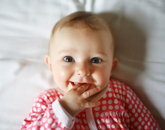 baby girl smiling at the camera in an article about literary girl names