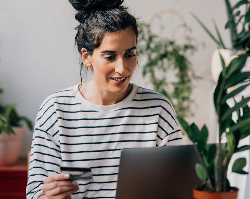 Woman using her credit card for shopping the best Labor Day sales online.