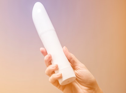 Woman exploring sexual pleasure with a new sex toy vibrator.