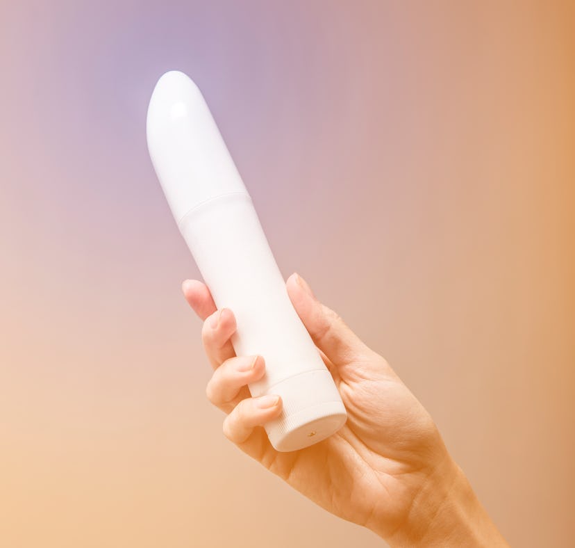 Woman exploring sexual pleasure with a new sex toy vibrator.