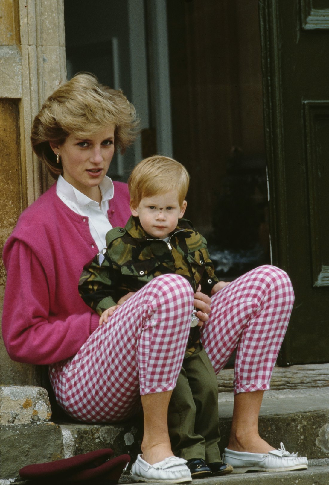 Princess Diane sits on a step with Prince Harry on her lap at Highgrove Estate, Doughton, Gloucester...
