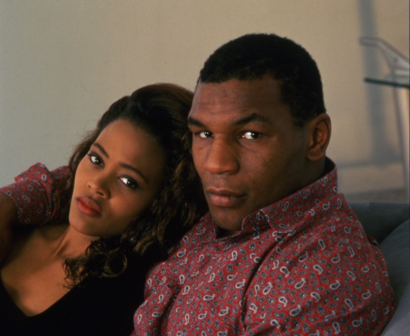 Portrait of American actress Robin Givens and her husband, heavyweight boxer Mike Tyson, as they sit...