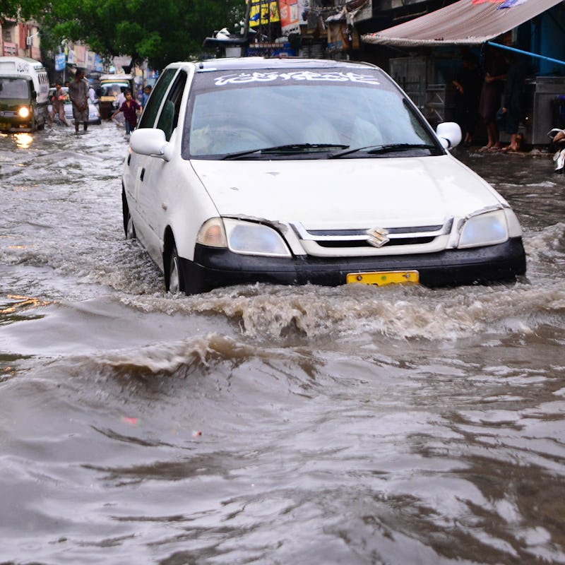 HYDERABAD, PAKISTAN, JULY 24: People hardly drive their vehicles through flooded street following he...
