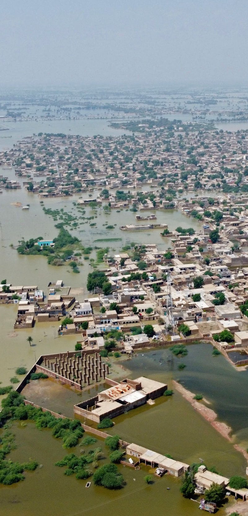 This aerial photograph taken on August 31, 2022 shows flooded residential areas after heavy monsoon ...