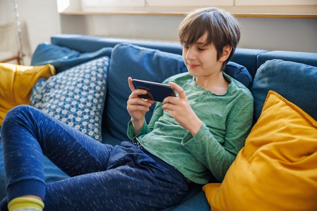 Boy sitting on a couch. California has just passed a new law that should make the internet safer for...