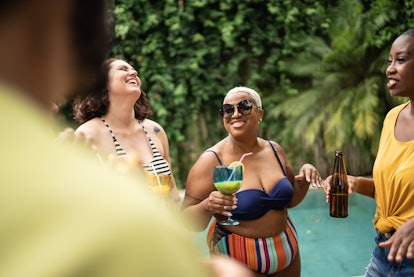 A woman celebrating her birthday with turning 30 quotes at a pool party.