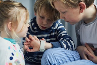 Siblings using a smart watch together