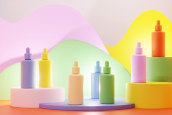 Multicolored serum bottles on vibrant podiums on colorful background.