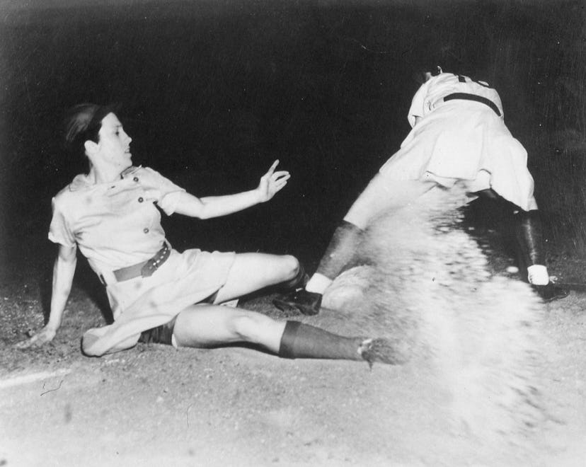ROCKFORD, ILLINOIS - 1946. Dorothy Kamenshek of the Rockford Peaches of the AAGBL slides safely int…