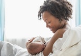 a mother and newborn in the midst of a breastfeeding session in an article about newborn choking or ...