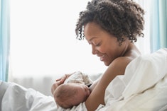a mother and newborn in the midst of a breastfeeding session in an article about newborn choking or ...