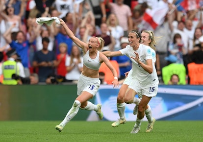 Chloe Kelly of England celebrates with team mates after scoring their side's second goal in extra ti...