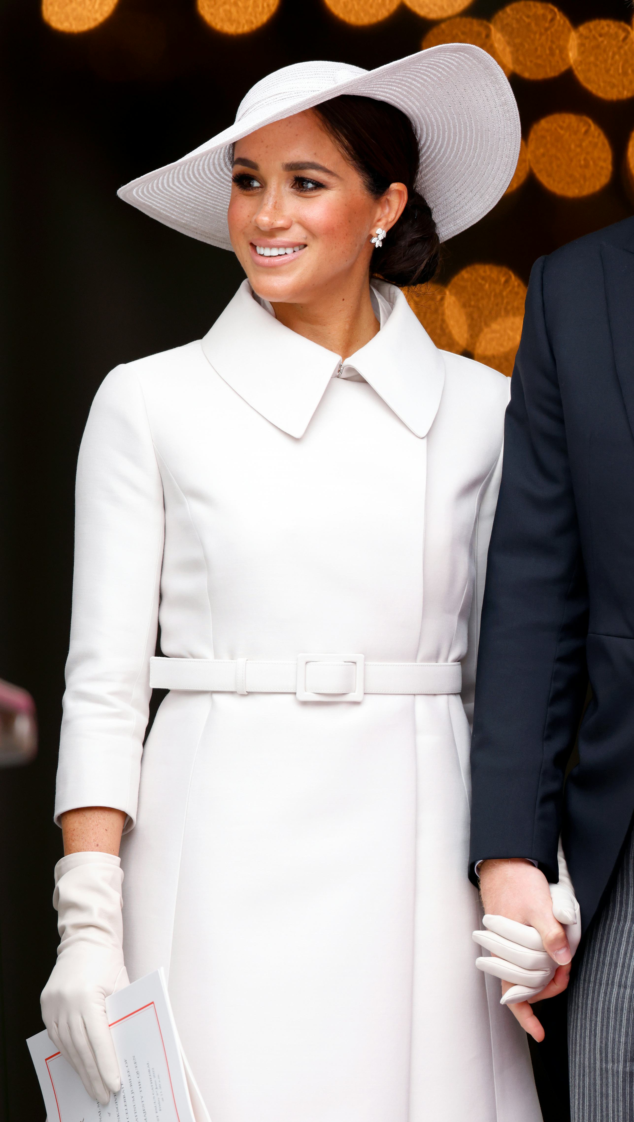 Meghan, Duchess of Sussex, in an all-white outfit attends a National Service of Thanksgiving to cele...
