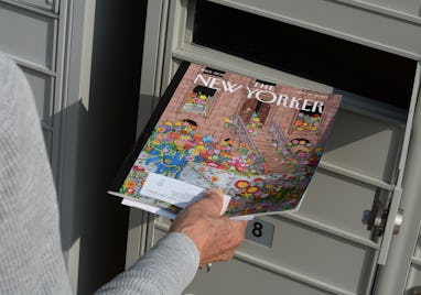 SANTA FE, NEW MEXICO - FEBRUARY 8, 2020: A woman retrieves a copy of The New Yorker magazine from h...