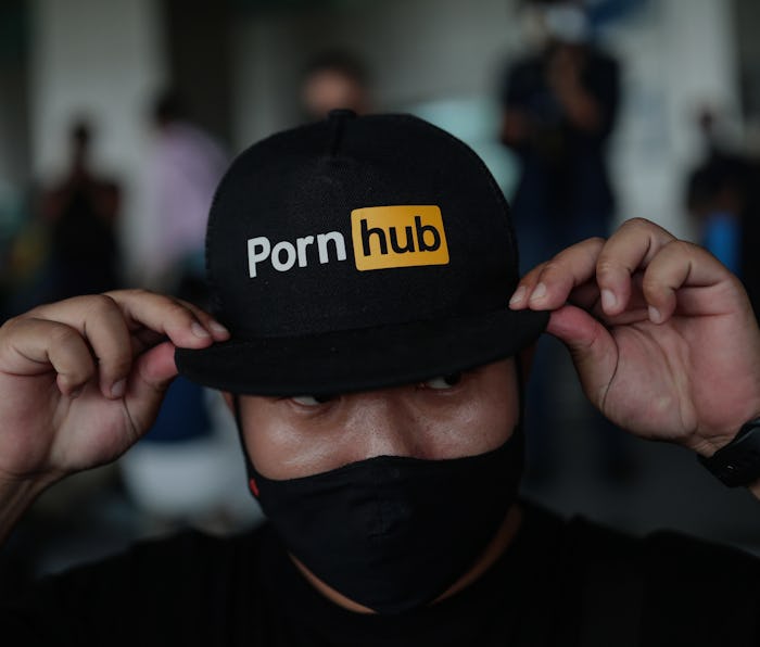 A protester wears a cap with the Pornhub logo during a demonstration at the Ministry of Digital Econ...