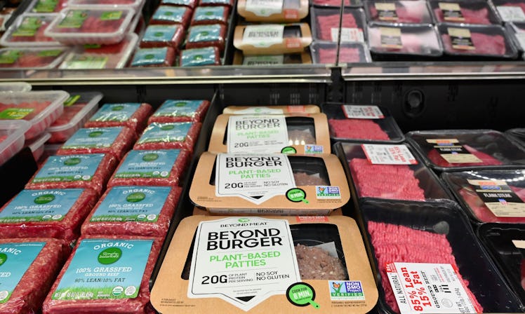 Beyond Meat "Beyond Burger" patties made from plant-based substitutes for meat products sit alongsid...