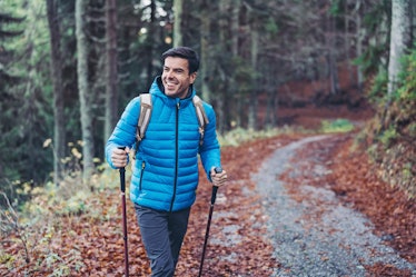 Smiling hiker walking in the mountain