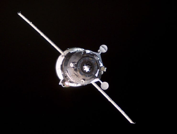 Backdropped by the blackness of space, an unpiloted Progress supply vehicle approaches the aft port ...