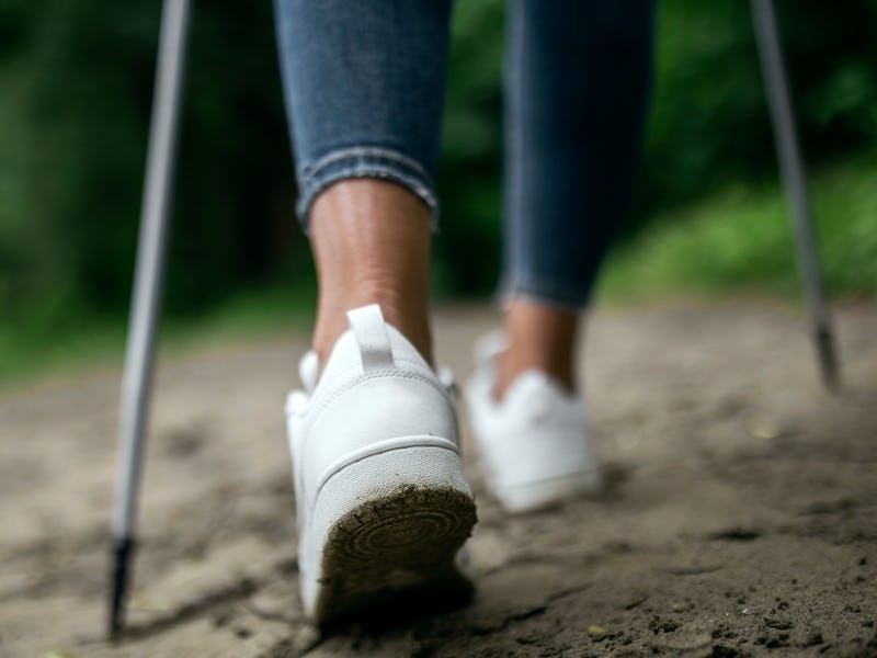 Low angle view of a woman with hiking pole