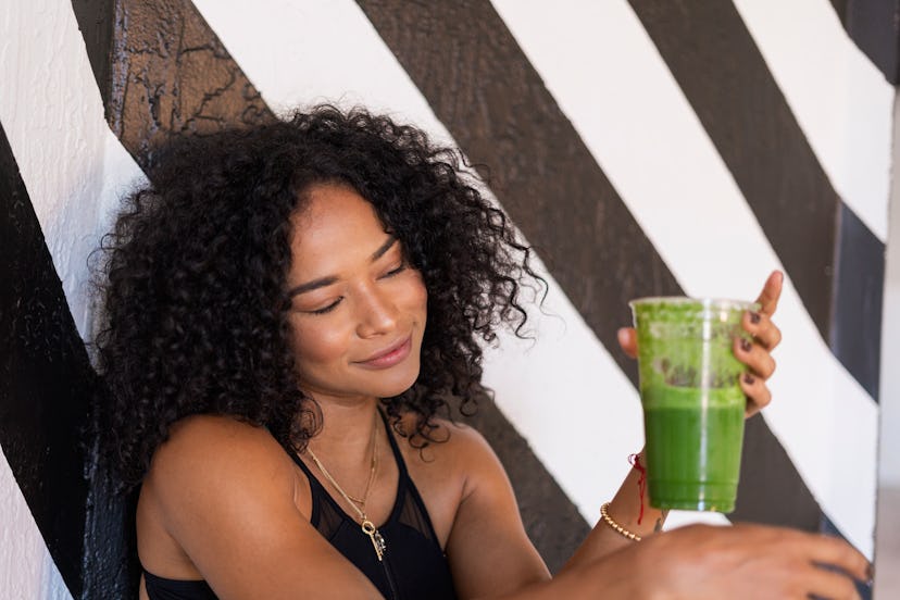 woman drinking green juice