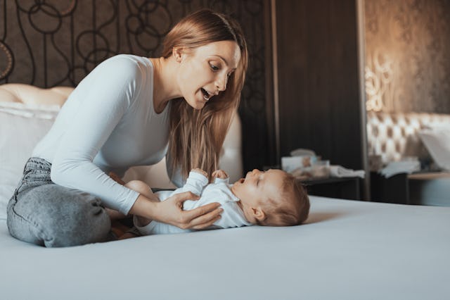 A mother sings a lullaby to her newborn baby girl, which could help with emotional regulation.