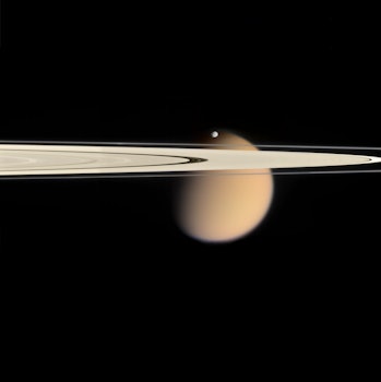 Titan on the far side of Saturn's A and F rings, with tiny Epimetheus on the near side.  Mosaic composition...