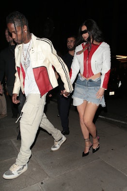 Travis Scott and Kylie Jenner wearing matching red and white moto jackets for dinner in London, Engl...