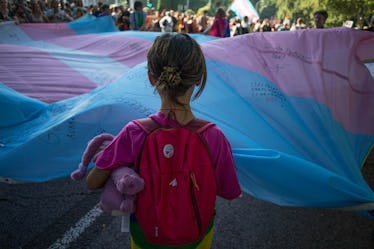 A little kid faces a trans pride flag