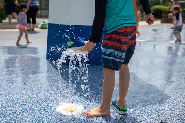 WASHINGTON, D.C.  - MAY 21: Josiah Li, 5, plays in a splash pad at Turkey Thicket Recreation Center ...