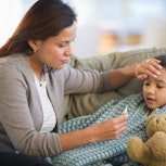 Mother taking her child's temperature. Australia's intense flu season has U.S. health experts warnin...