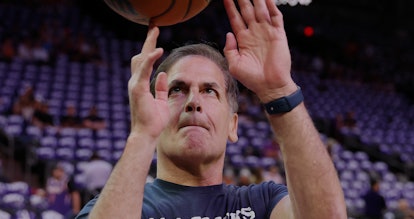 PHOENIX, ARIZONA - MAY 15: Dallas Mavericks owner Mark Cuban spins a basketball before Game Seven of...