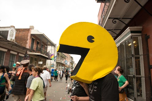 In New Orleans, United States a man wearing a large Pac Man head on the street during Mardi Gras in ...