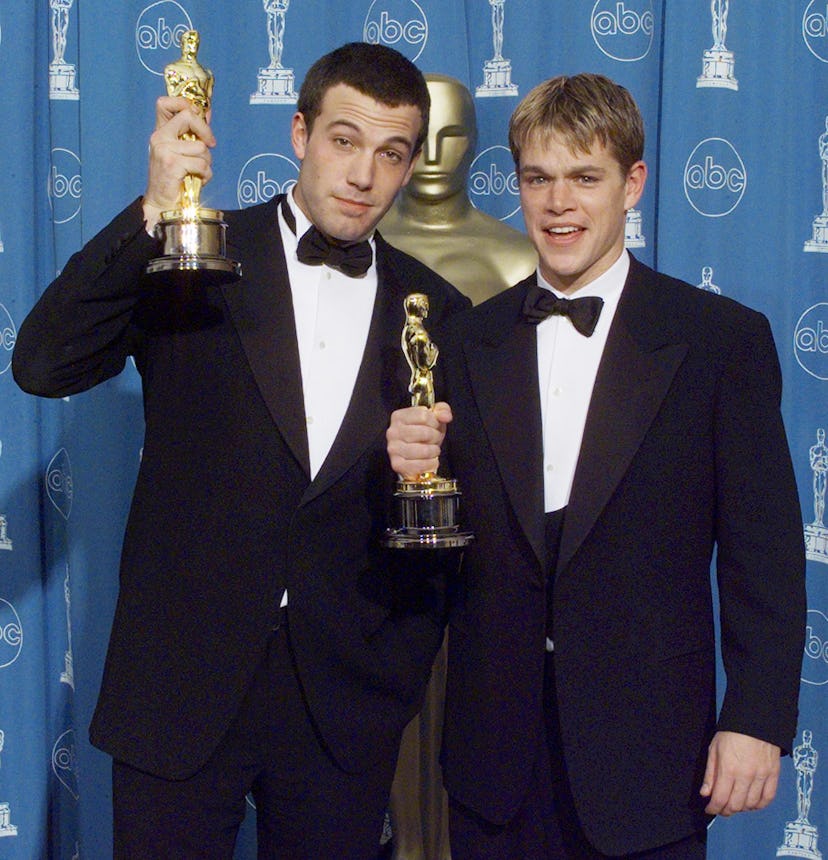 Matt Damon (R) and Ben Affleck (L) pose with their Oscars they won for Best Original Screenplay for ...