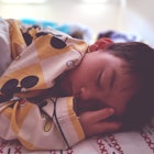 A child sleeping in bed.