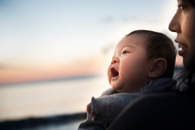 mother and baby at sunset by the ocean in a round up of literary baby names