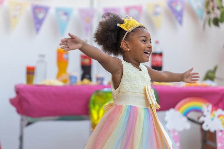 5 year old toddler happily dancing excited as her birthday party