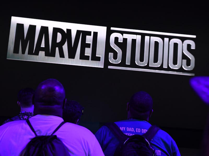 Attendees watch Marvel Studios visual at the Disney+ booth at the D23 Expo, billed as the "largest D...