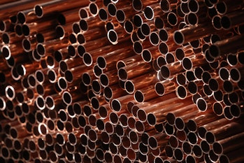 Copper pipes stacked in a storage area. Photographer: Oliver Bunic/Bloomberg