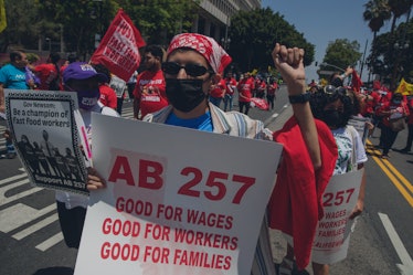 Los Angeles, CA - June 09:  Fast-food workers lead a march to the state building on Spring Street af...