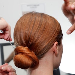 NEW YORK, NEW YORK - SEPTEMBER 07:  A model is getting prepared backstage during TRESemme X Christia...