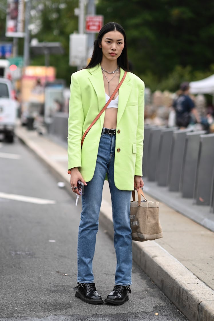 NEW YORK, NEW YORK - SEPTEMBER 11: Model Bingbing Liu is seen wearing a lime green jacket, white bra...