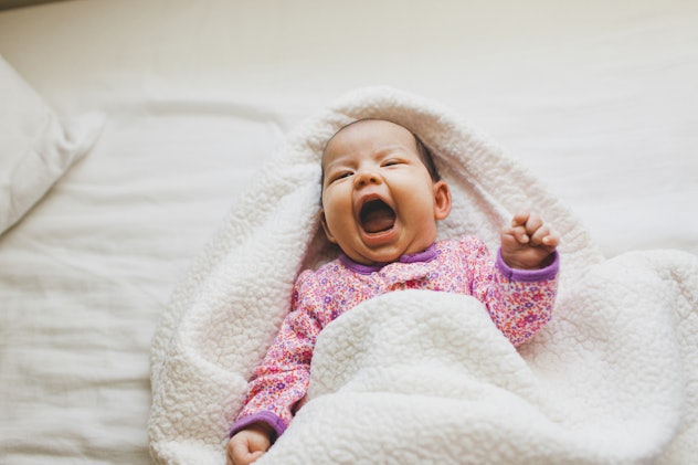 a cute baby in a blanket in a round up of girl names that start with "T"