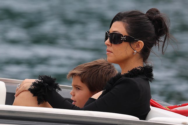 Kourtney Kardashian, in black, on a boat with her son Reign Disick