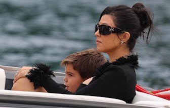 Kourtney Kardashian, in black, on a boat with her son Reign Disick