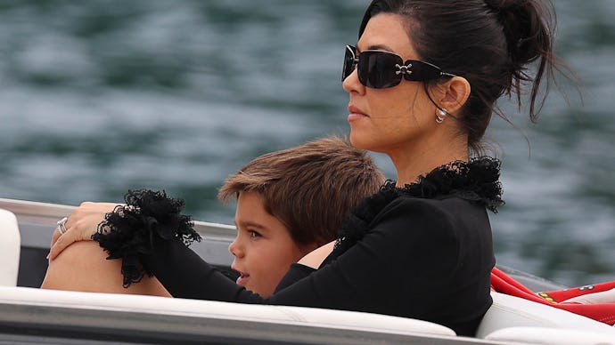 Kourtney Kardashian, in black, on a boat with her son Reign Disick